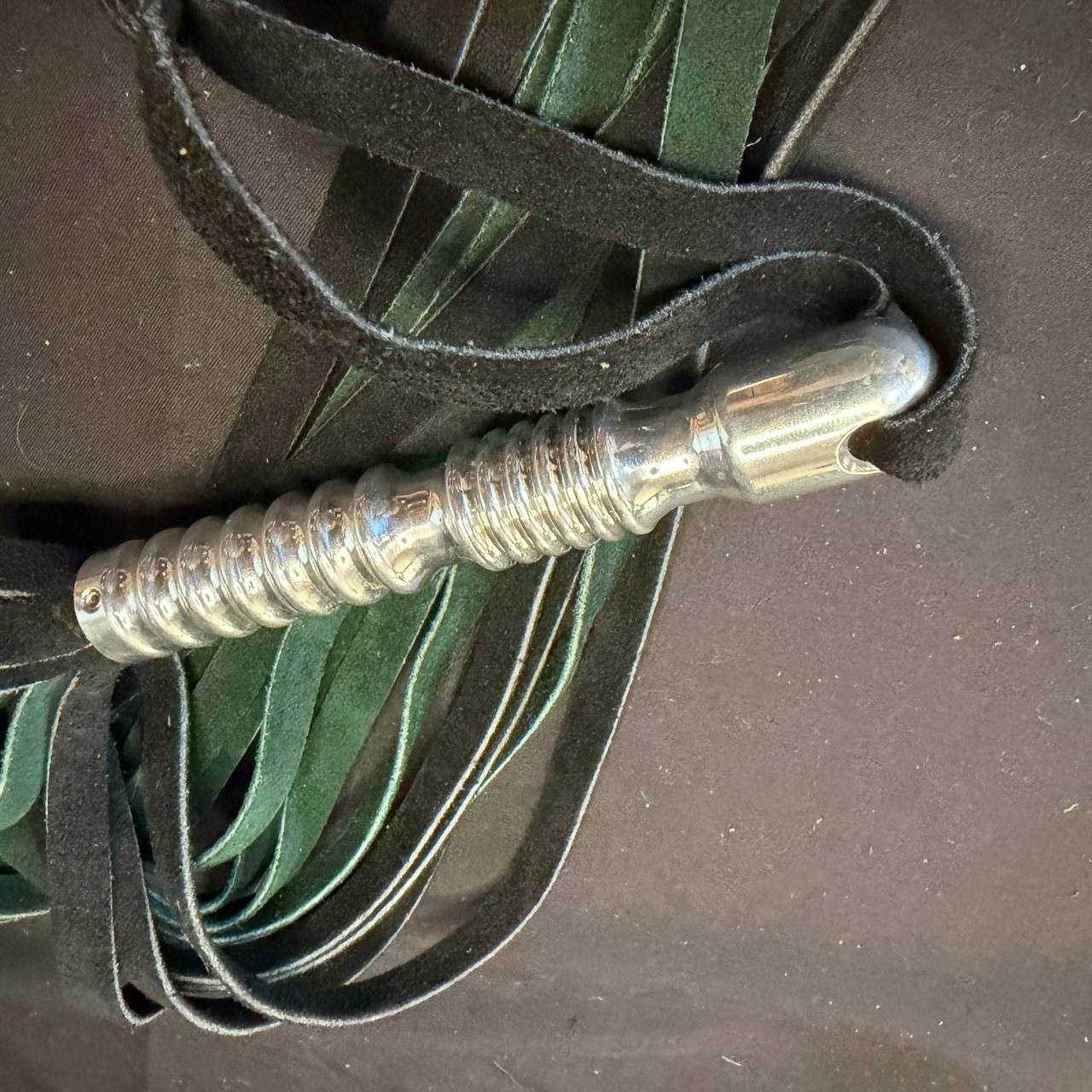 Green and black suede flogger with aluminum handle - 15 inch falls 5 inch handle