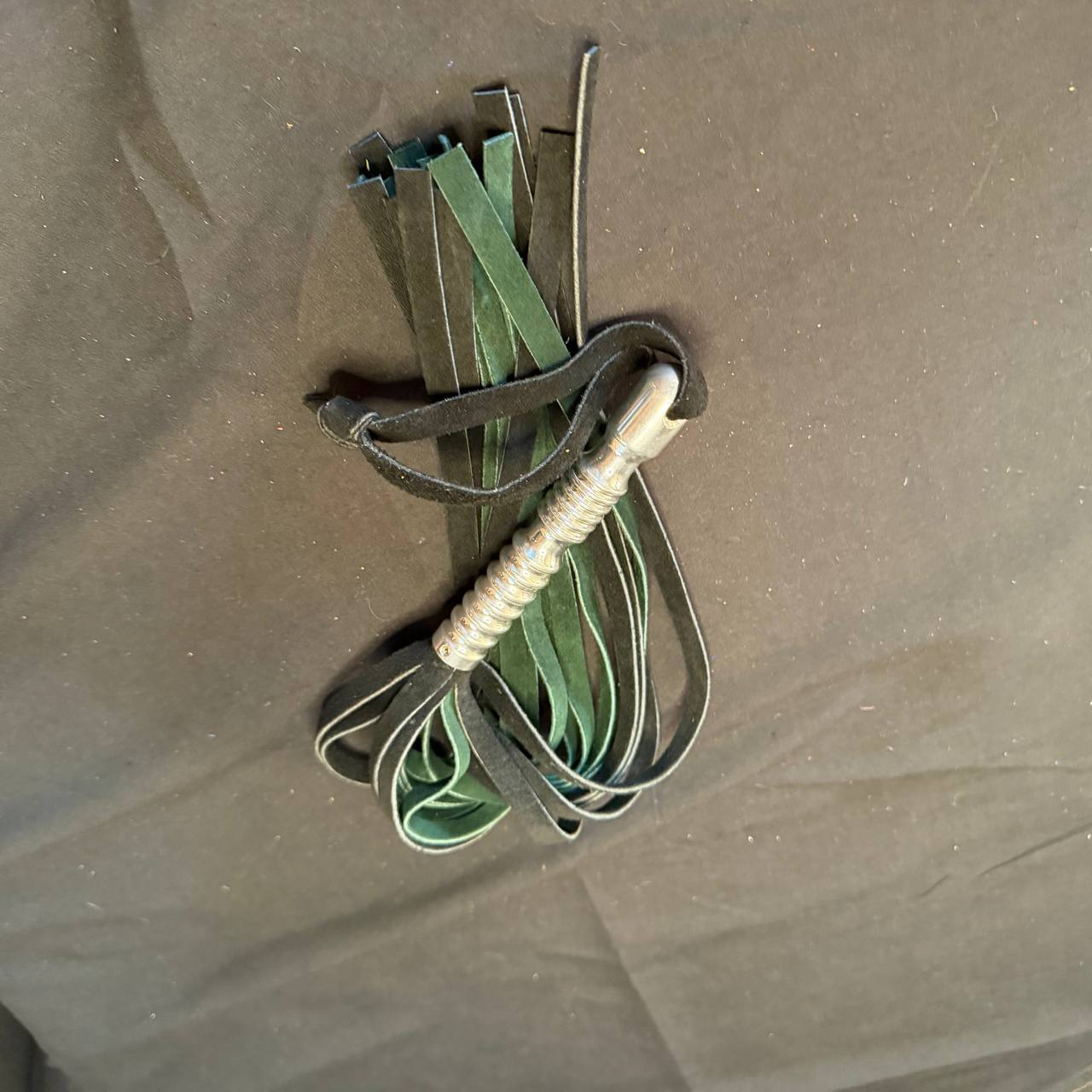 Green and black suede flogger with aluminum handle - 15 inch falls 5 inch handle